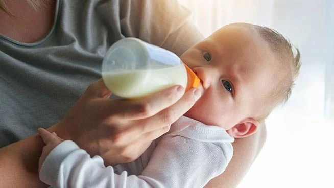 Mom bottle-feeding baby