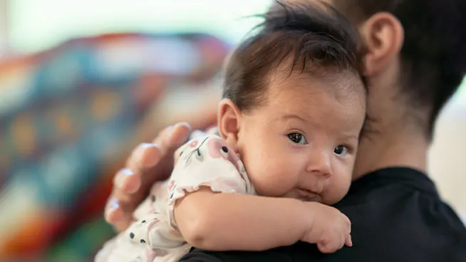 Dad holding newborn baby