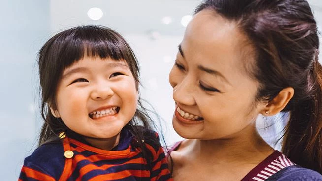 Mom and daughter smiling together