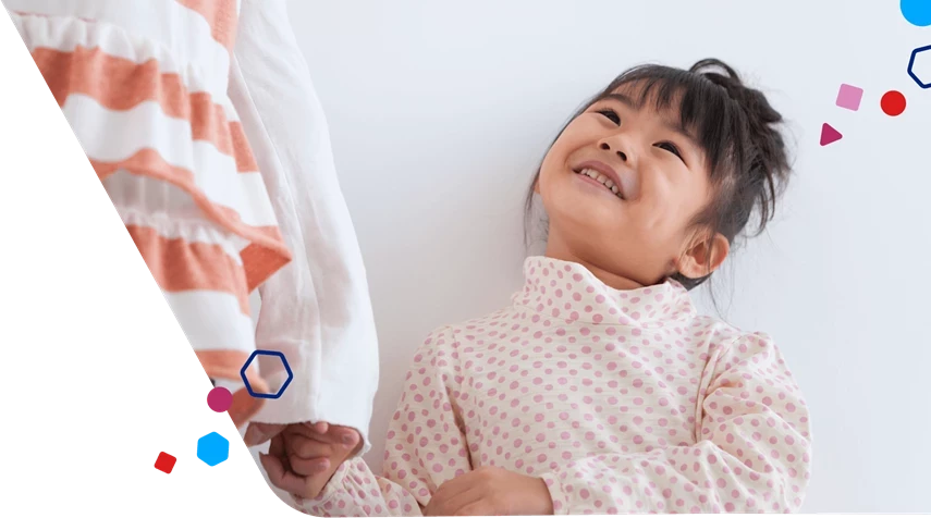Toddler girl smiling up at mom