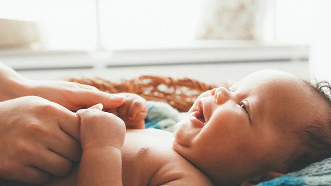 Parent changing their baby's diaper