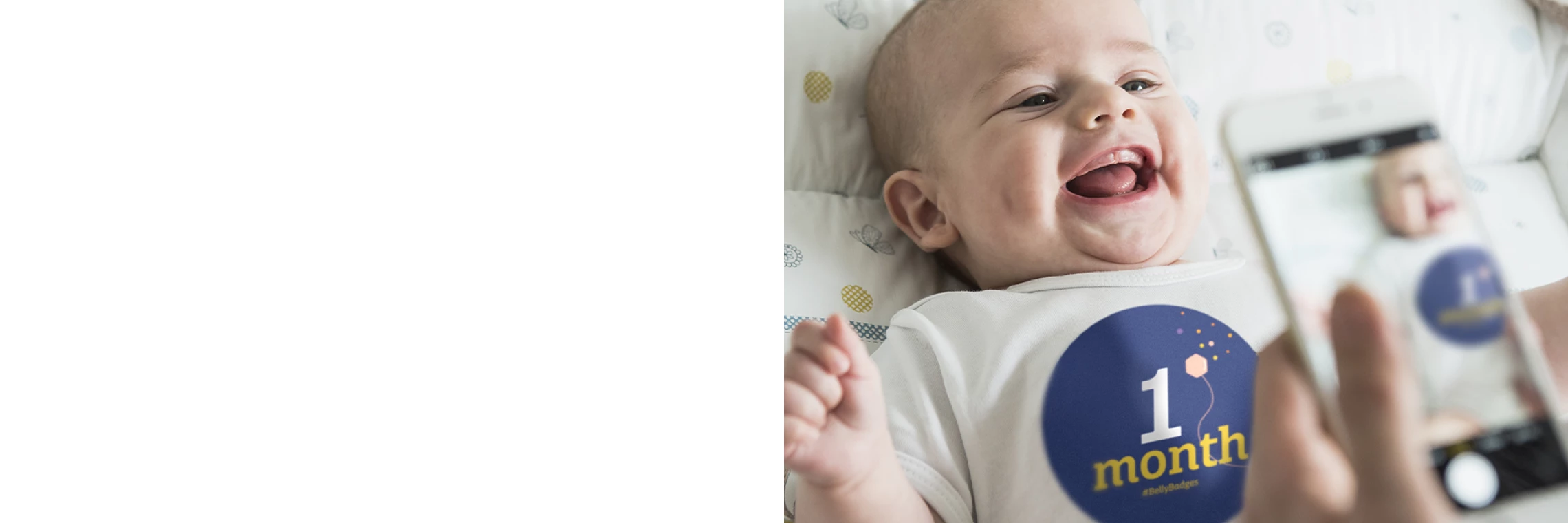 Parent taking a picture of their 1 month old baby wearing a BellyBadge™