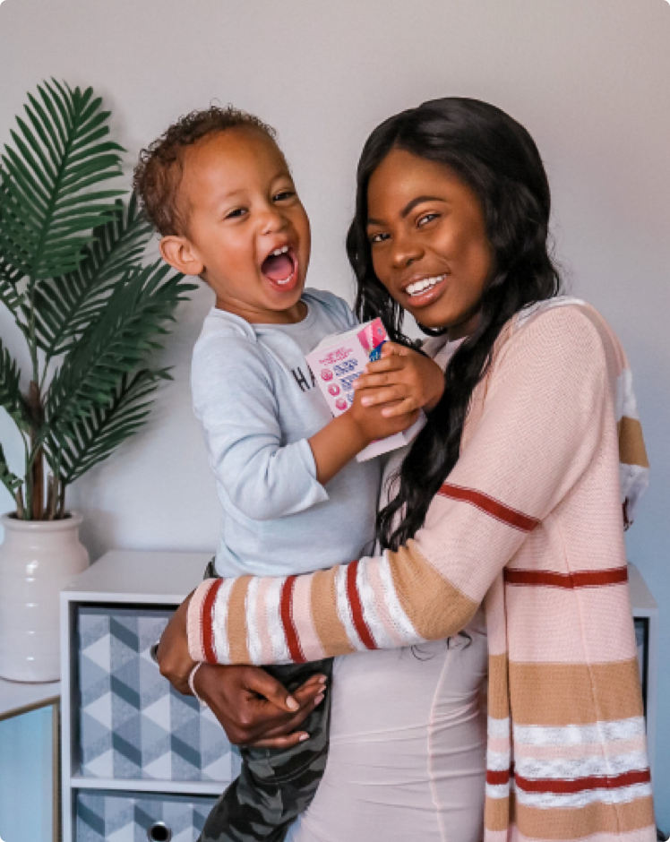 Mother Holding Toddler With Enfamom™ Prenatal Vitamins