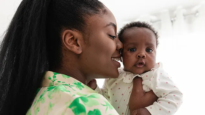 Mom holding baby, as baby has hiccups 