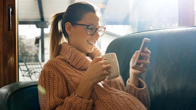 Pregnant mom drinking tea and looking at her phone