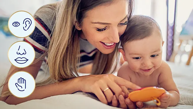 Mom showing baby how to use toy