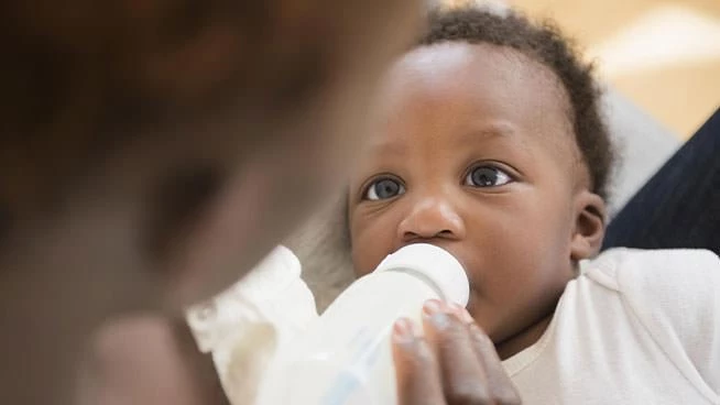 Mom bottle-feeding baby