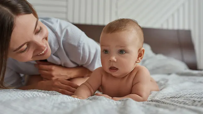 Mom encouraging newborn