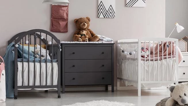 Two cribs in a nursery