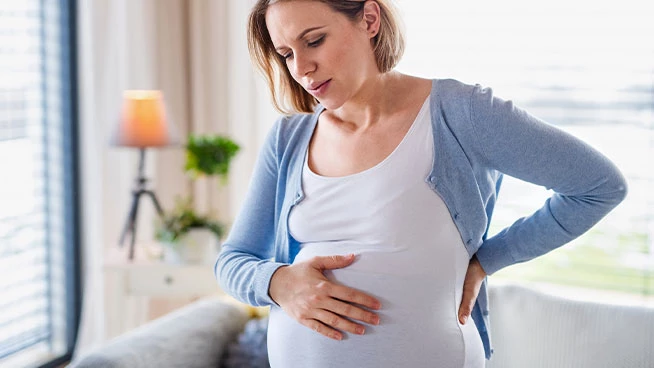 Pregnant woman holding her stomach