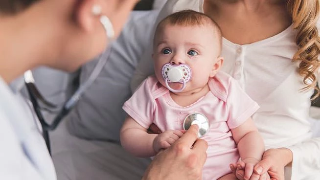 Doctor giving baby girl a checkup