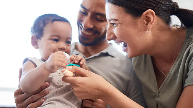 Mom and dad playing with newborn