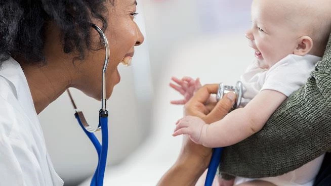 Pediatrician smiling at baby