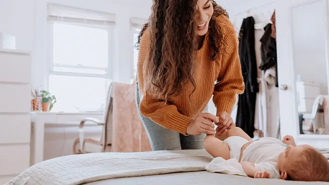 Mom playing with newborn's feet