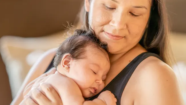 Mom holding her infant close