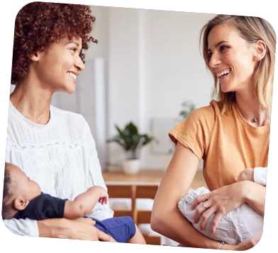 Two Mothers Talking While Holding Babies