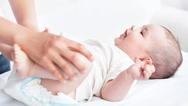 Parent changing baby's diaper