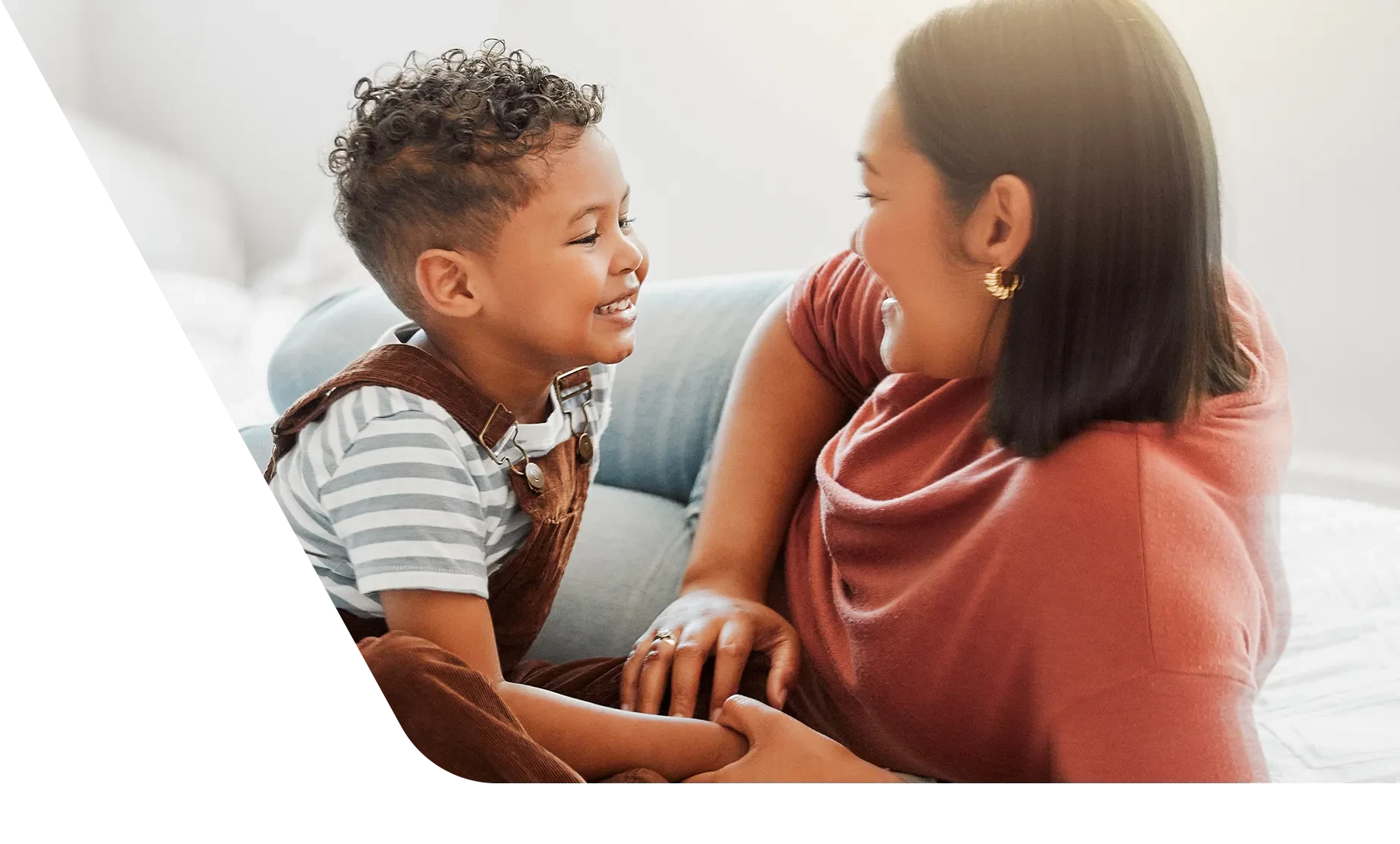 Mom and son sitting on floor talking to each other