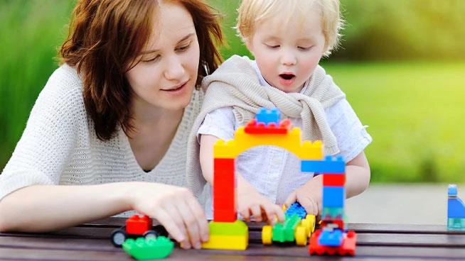 Mom and toddler playing with legos