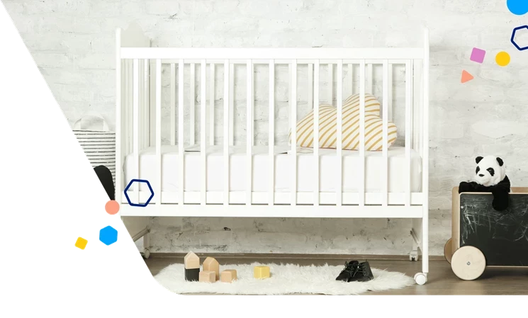 A white crib with a fluffy rug in front of it