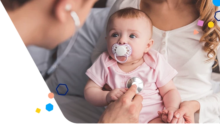Baby with a pacifier being held by her mother while a pediatrician listens to her chest