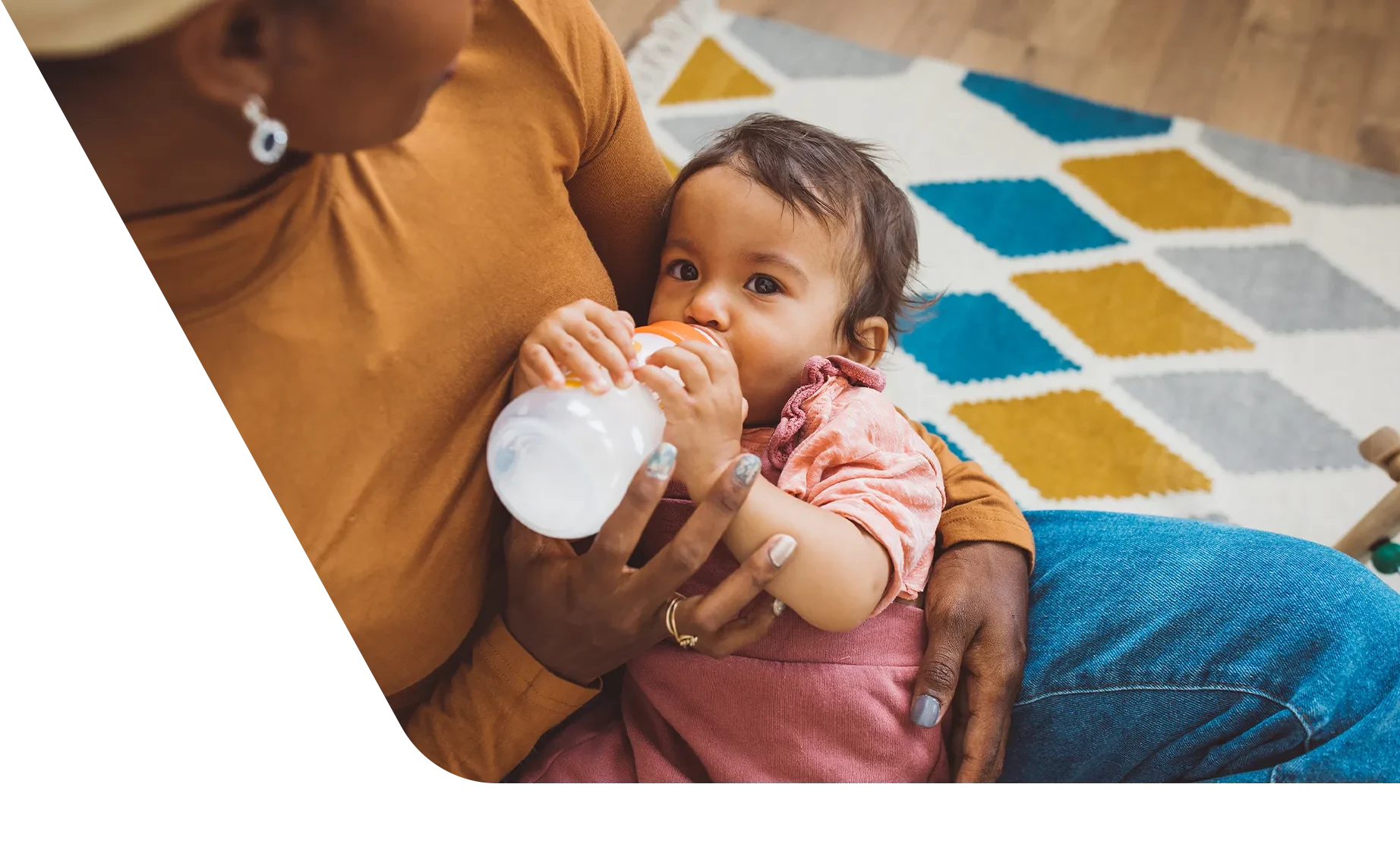 Mom cradling baby and feeding her a bottle