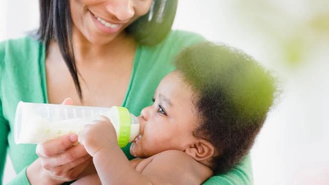 Mom feeding her baby a bottle